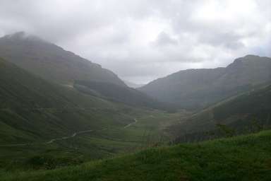 Picture of a view into a glen (valley), clouds above and rain falling