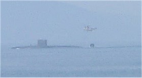 Picture of a submarine and helicopter exercising