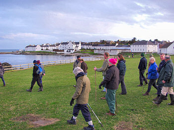 Picture of walkers with Port Charlotte in the background