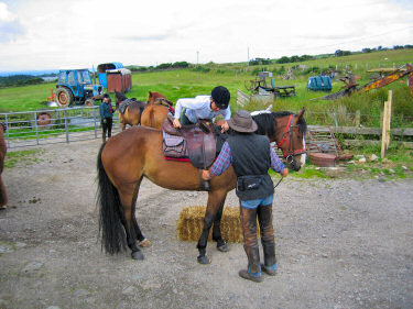 Picture of a rider mounting a horse