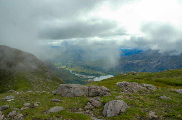 Picture of a view from a mountain ridge with clouds moving in