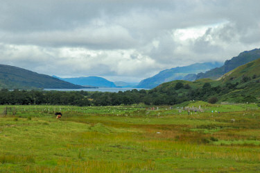 Picture of a loch, clouds above but brightening up