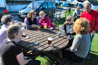 Picture of a group of people sitting around a table with drinks