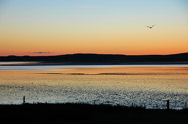 Picture of a colourful sky after sunset over a sea loch